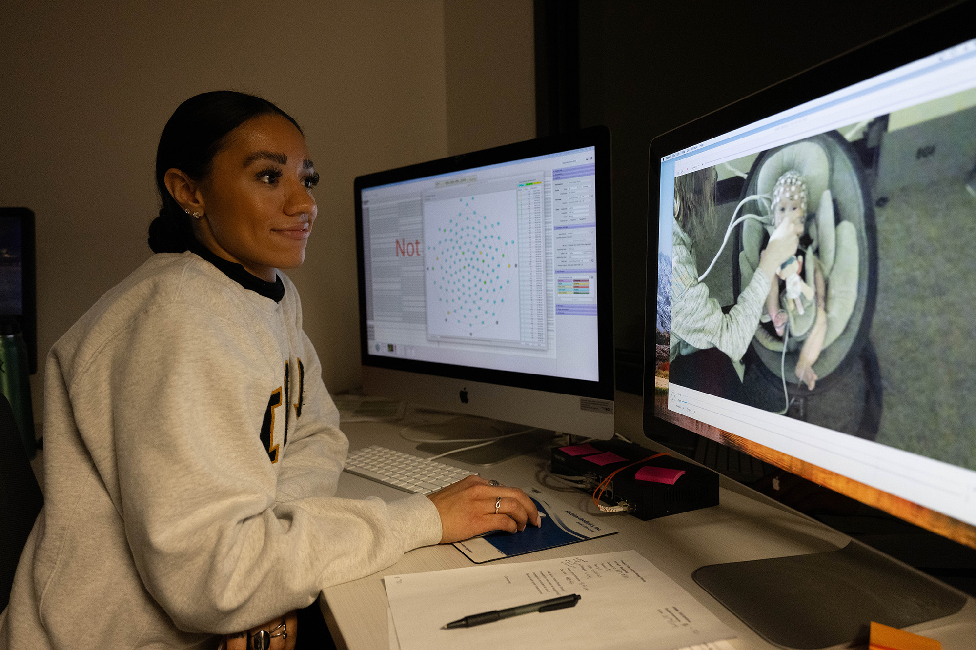 A woman sitting at a computer analyzing data