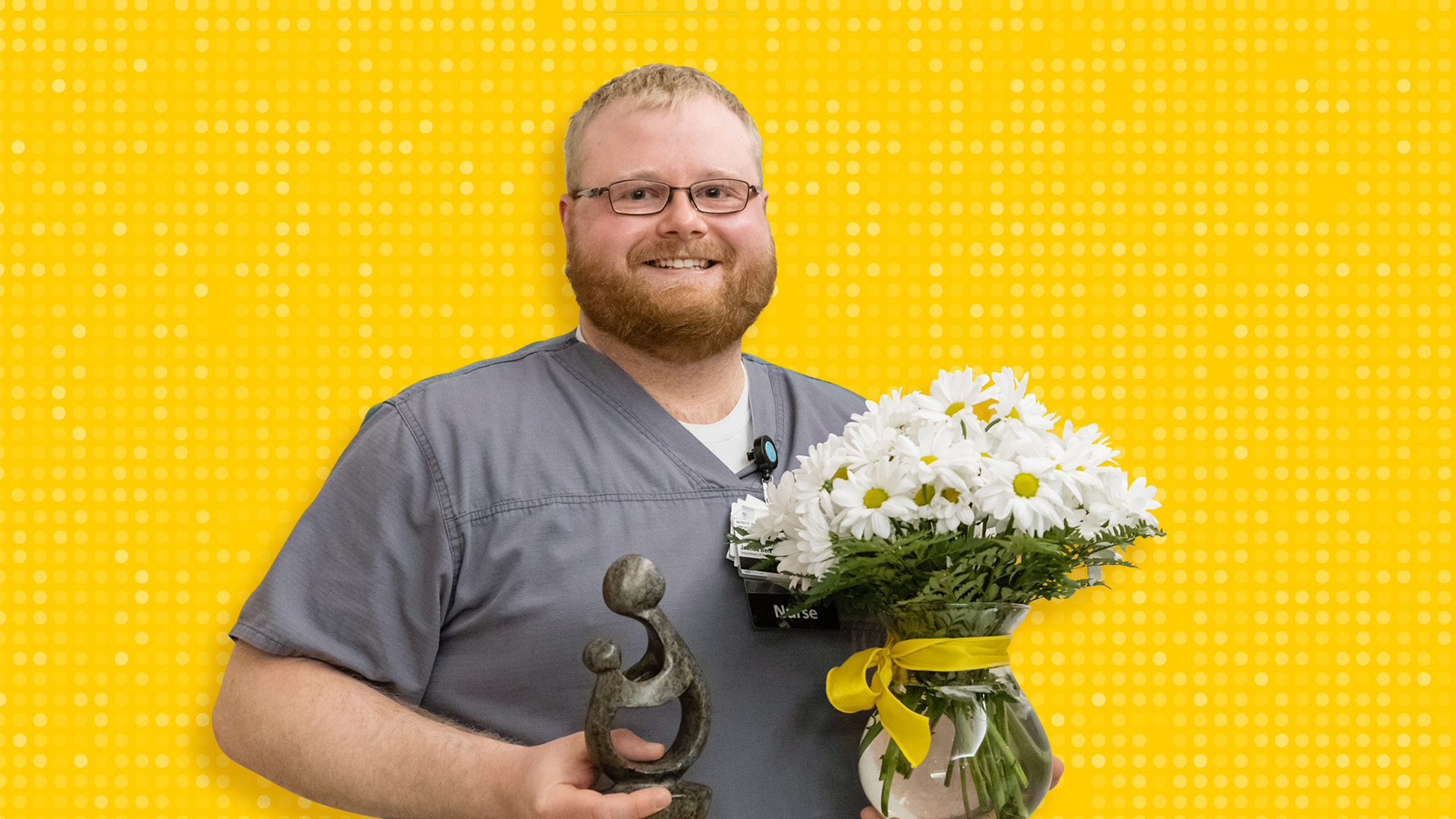 A man holding a vase of flowers and a sculpture