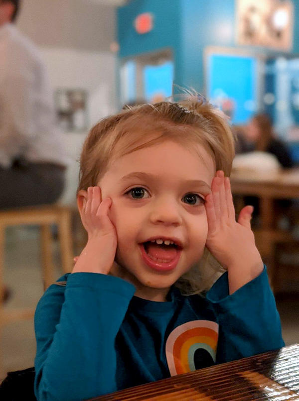 A girl holding her hands to her head
