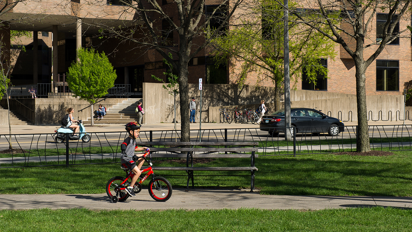 A boy riding a bike through a park