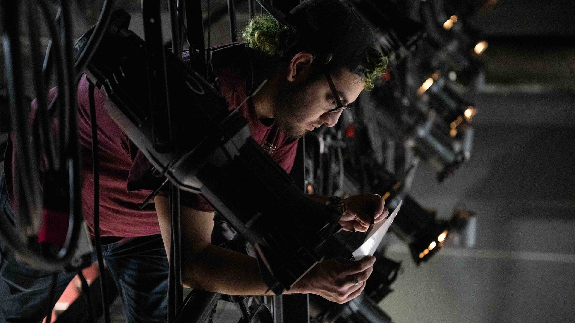a student working on lighting for a theater production