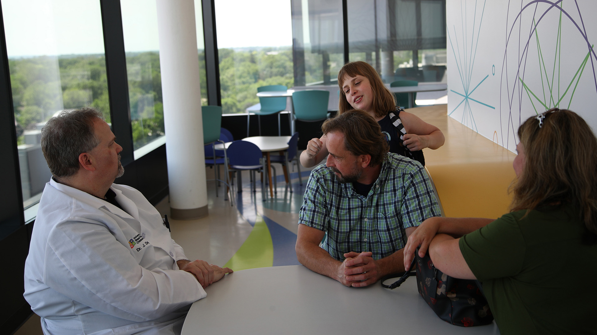 a group talking as a child plays