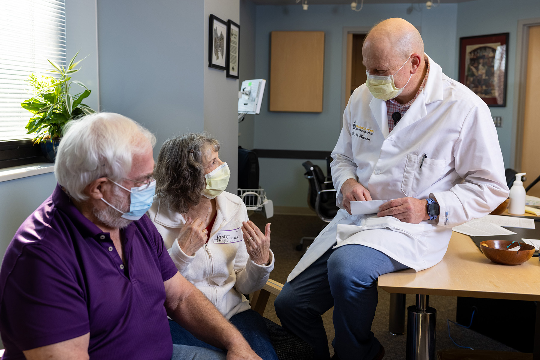 A doctor talking to two patients