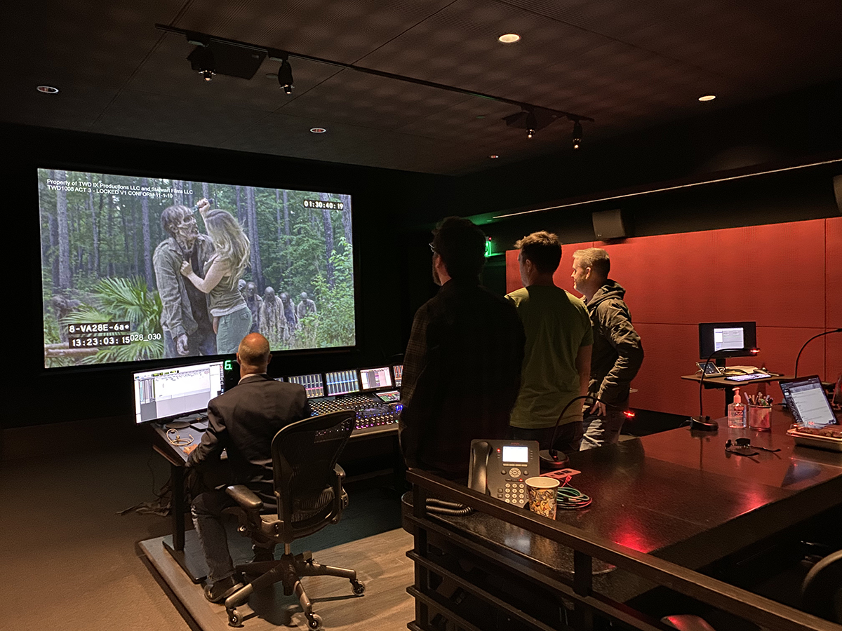 A group of people watching and editing a tv scene