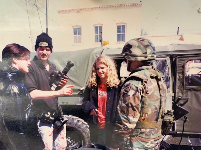 A soldier standing outside a truck