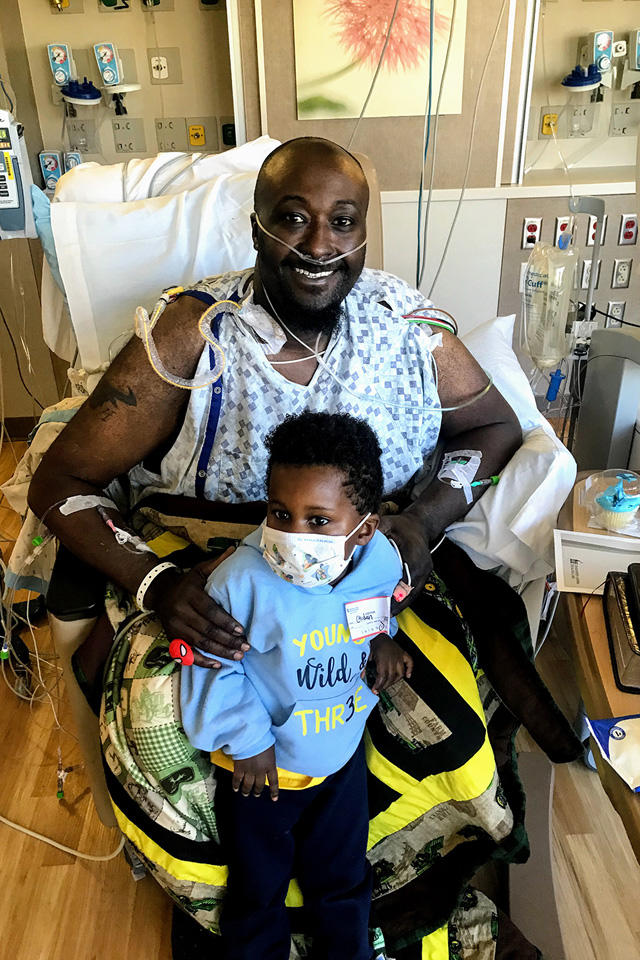 A man sitting in a chair with his son