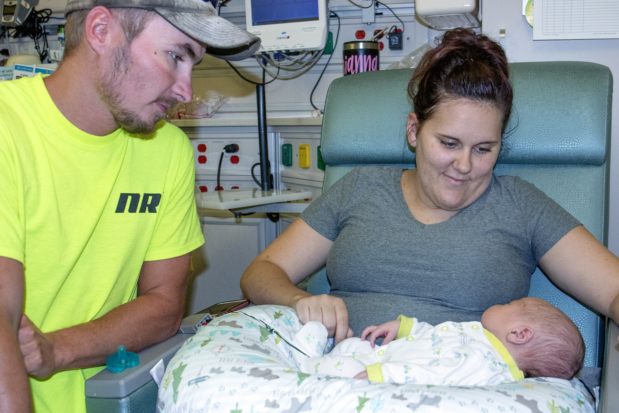 Parents looking at their newborn