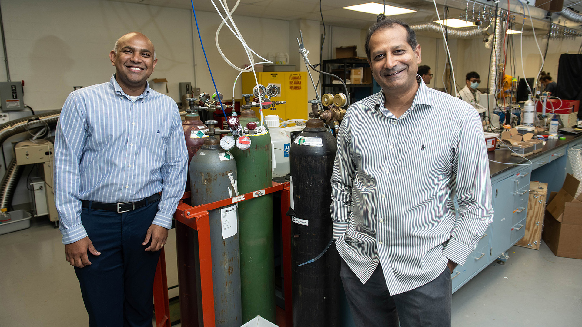 two men posing for a photo in a lab