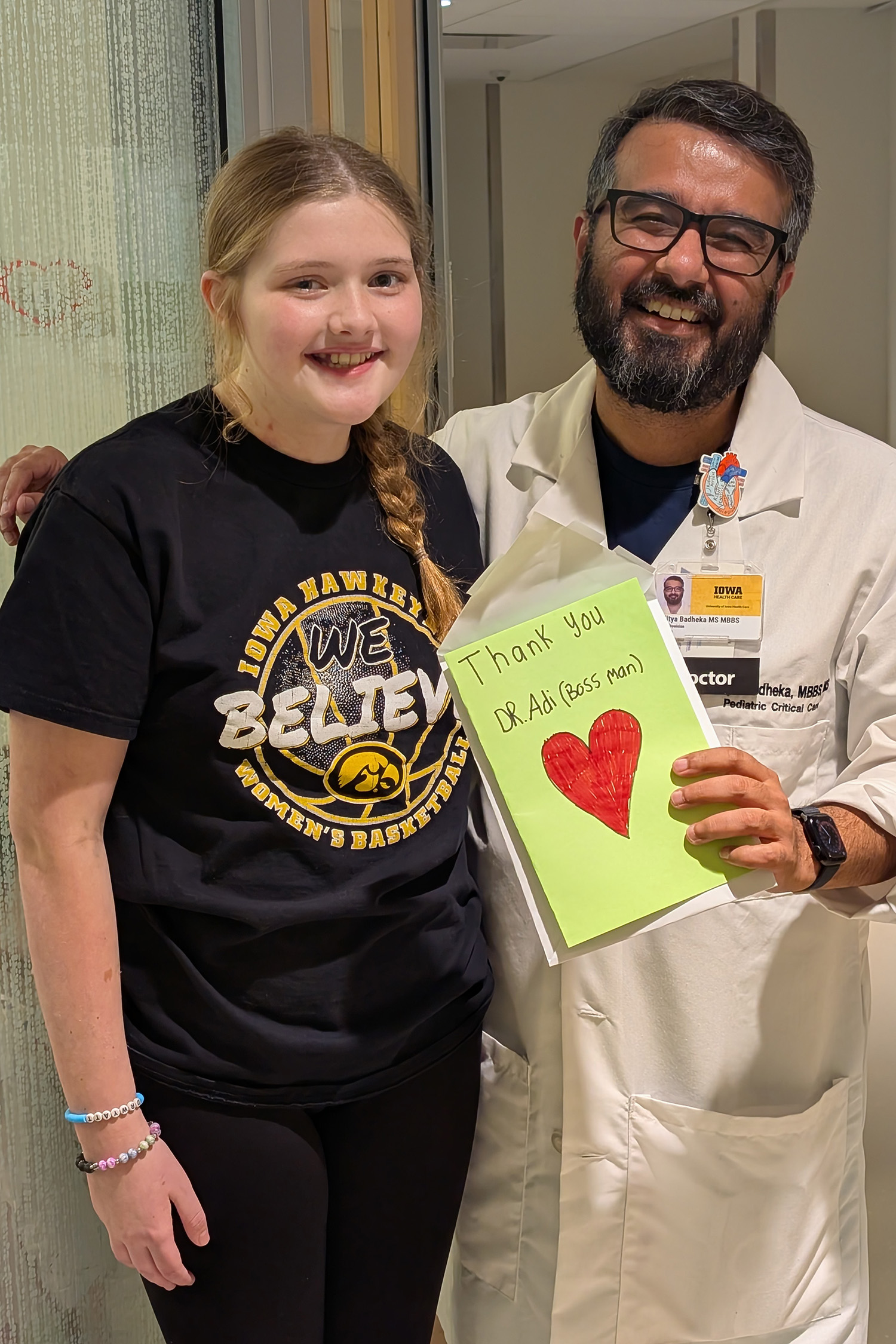 a girl with a doctor who is holding a card