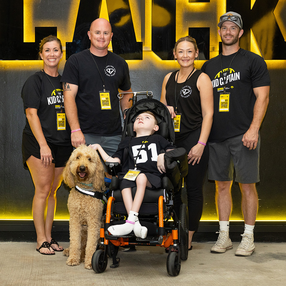 Kid Captain Liam Bartleson with family at Kids Day at Kinnick