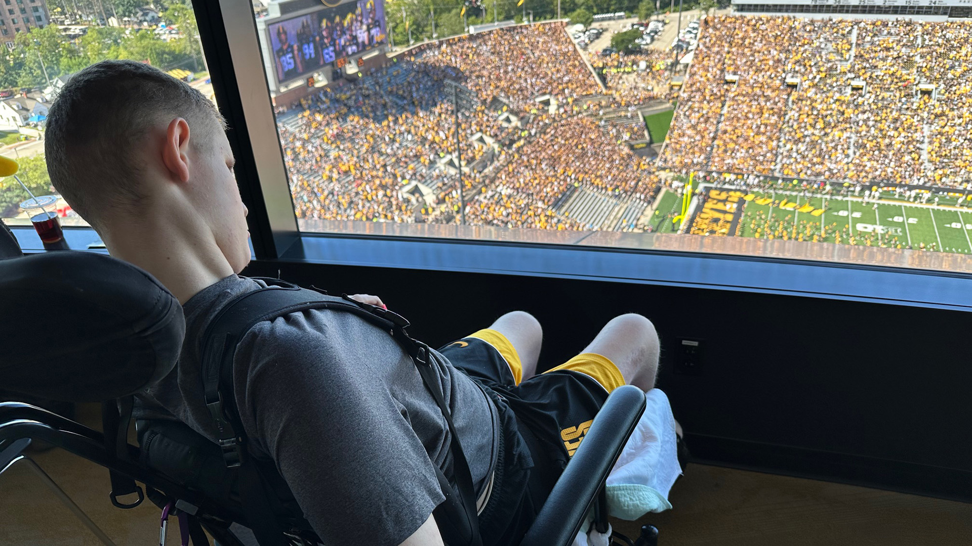 Jaxton Engstrom watching an Iowa football game from UI Health Care Stead Family Children's Hospital