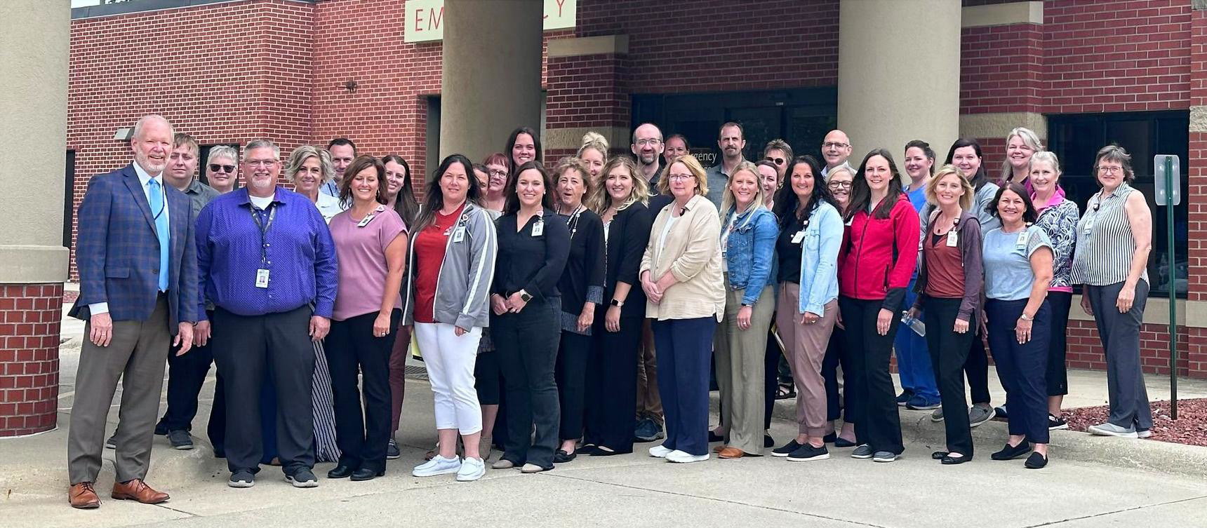 a large group standing outside a hospital