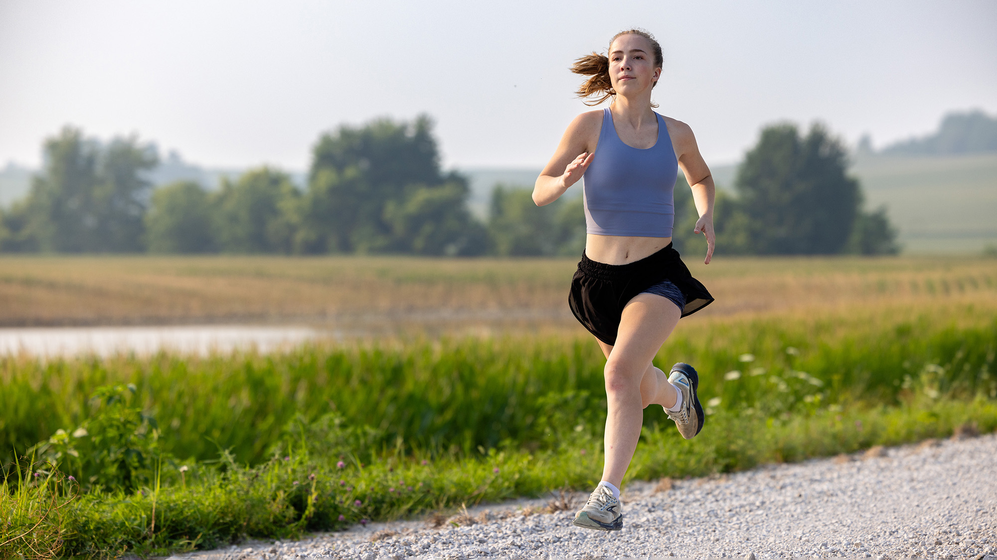 a young woman running on a rural road