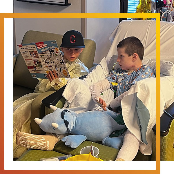 one boy visiting another young boy who was a patient at a burn unit