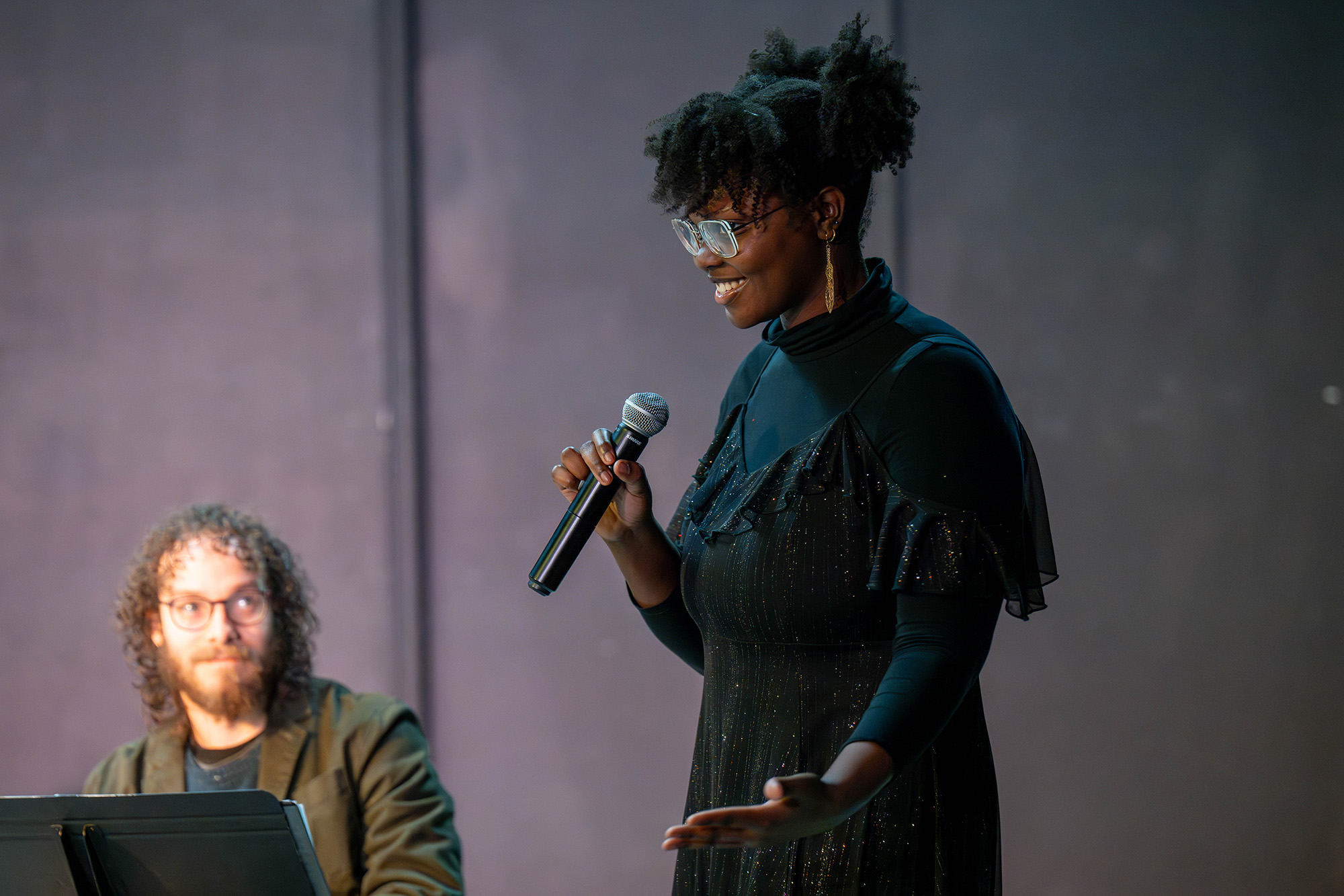 playwright Cianon Jones holds a microphone during a public staged reading of her play