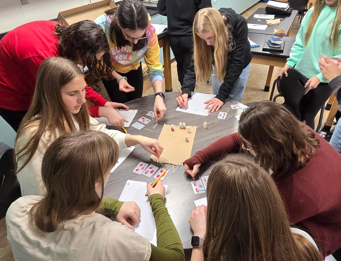 Carver College of Medicine student Megan Ahmann leads students through a synthetic blood-typing activity during her visit to Western Dubuque High School in December 2025