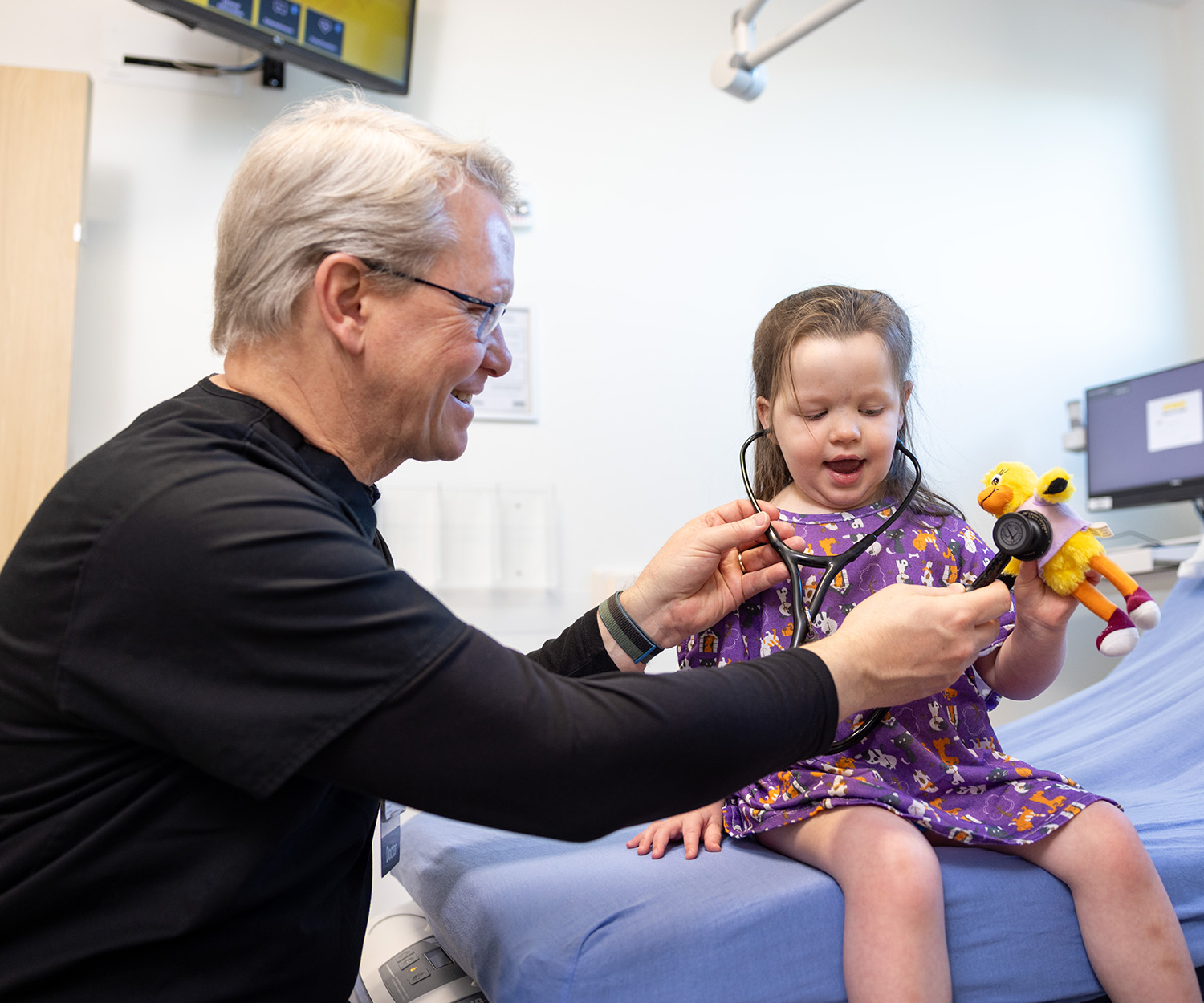 a doctor examines a young patient in the emergency department