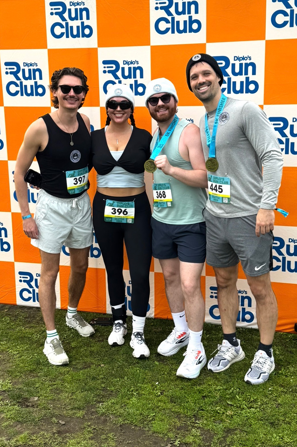 four people celebrating after running a race