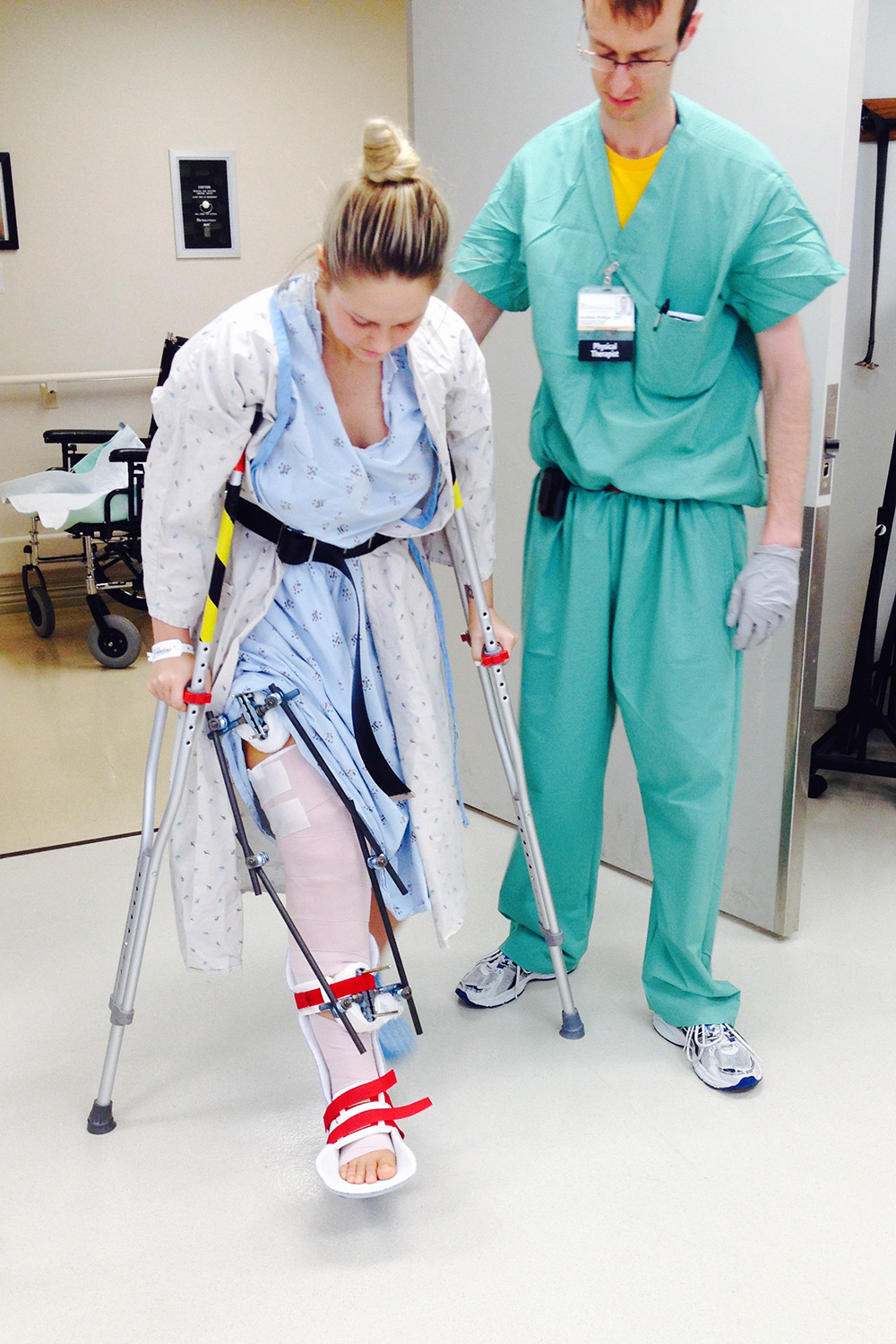 a young woman uses crutches during a rehab session