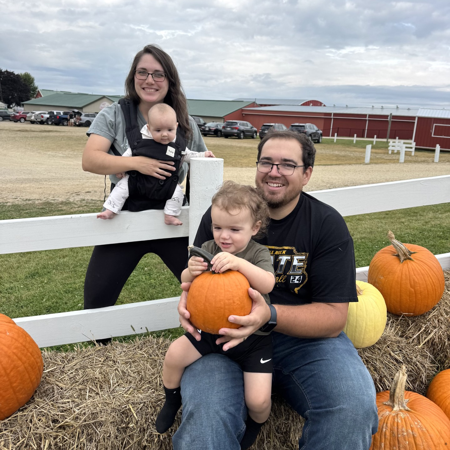 a family of four at a pumpkin patch