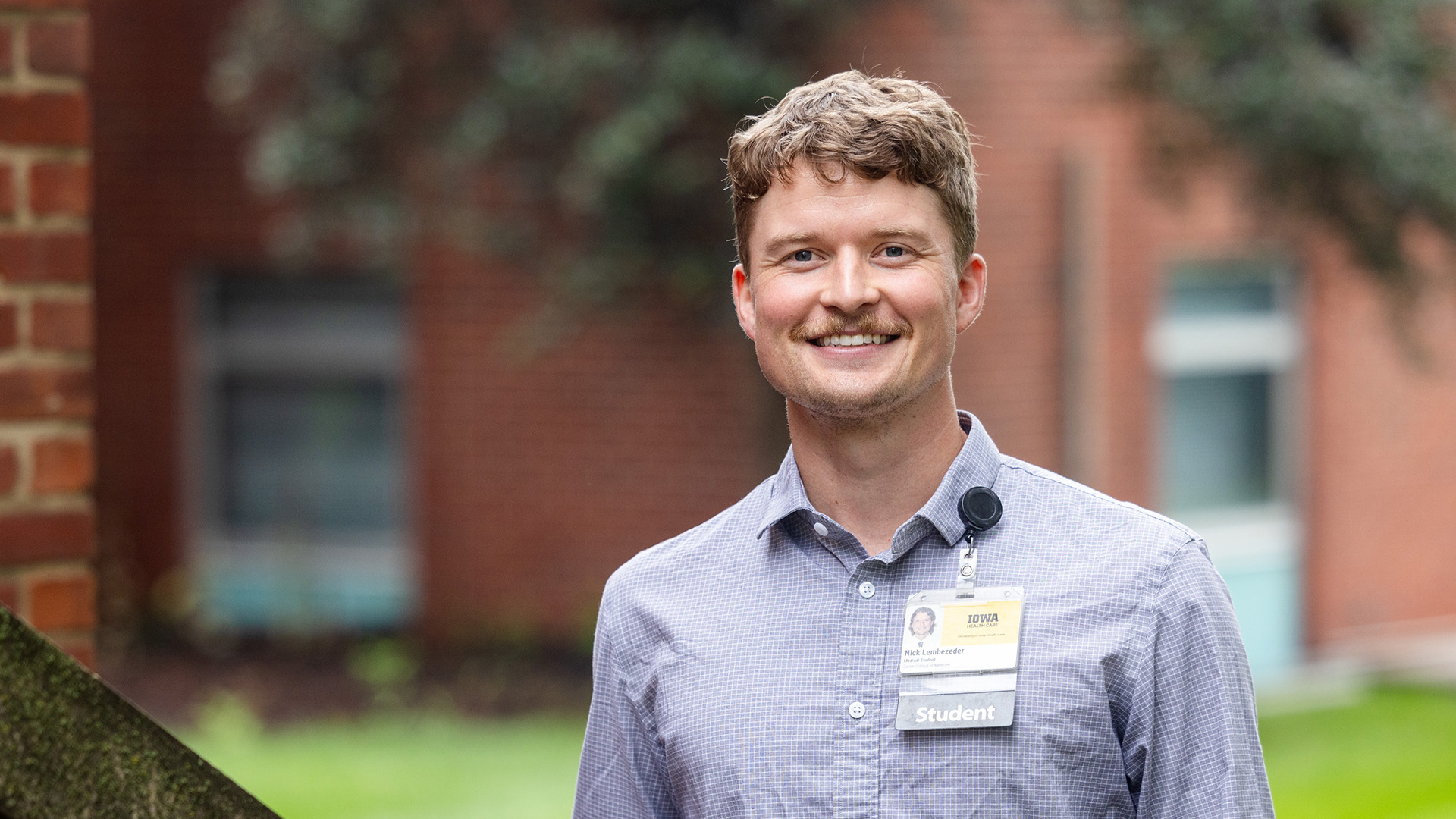 University of Iowa med student Nick Lembezeder stands outdoors on the UI campus