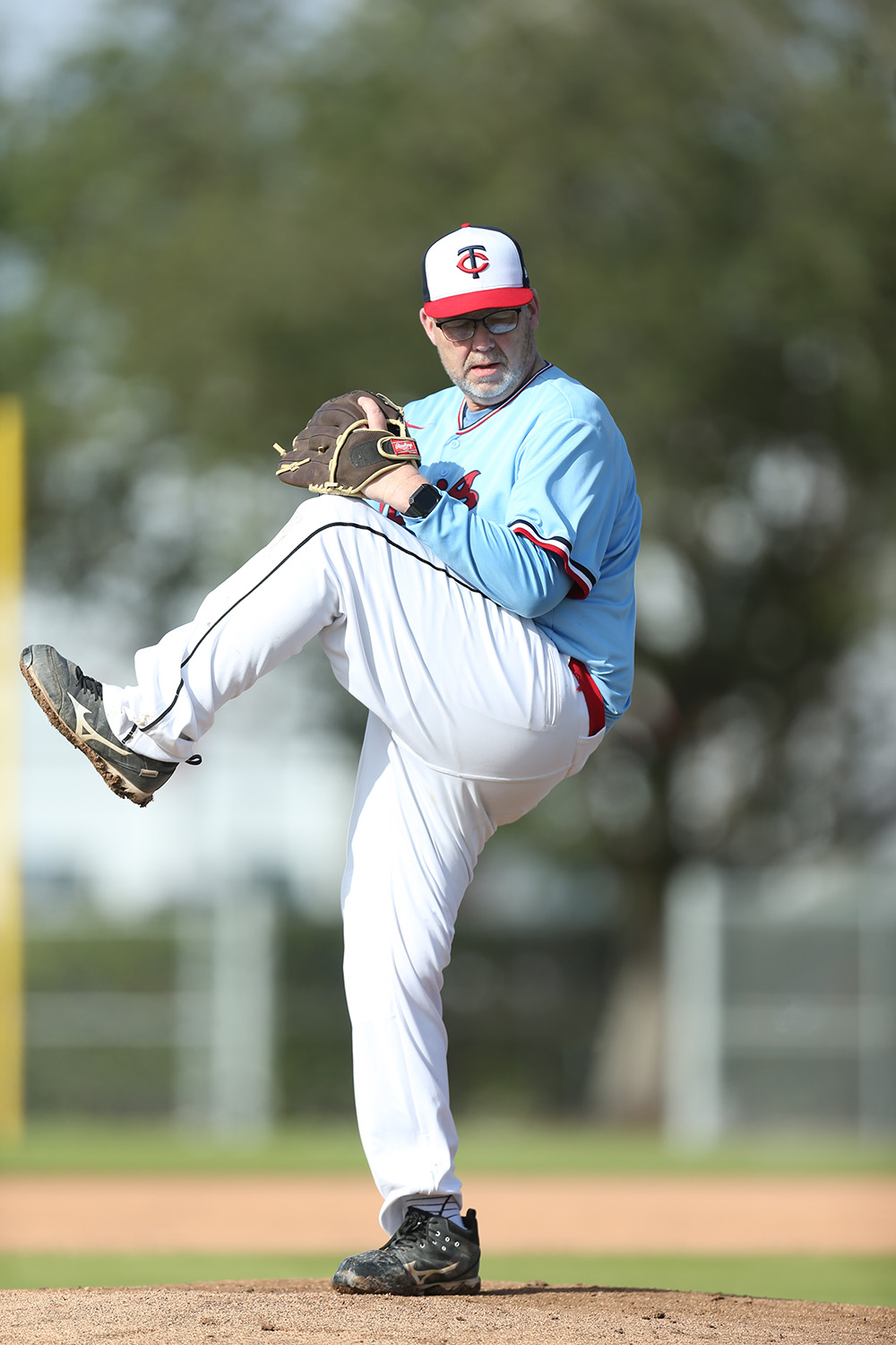 a man winding up to throw a pitch during a baseball game