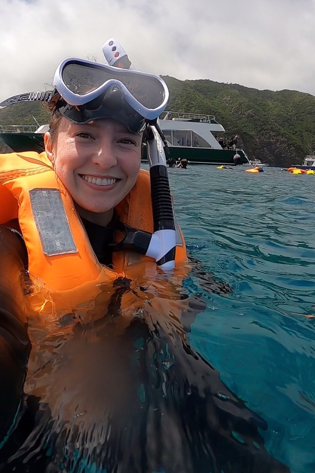University of Iowa dental student Ingrid Streitz smiling while in the water during a snorkeling excursion
