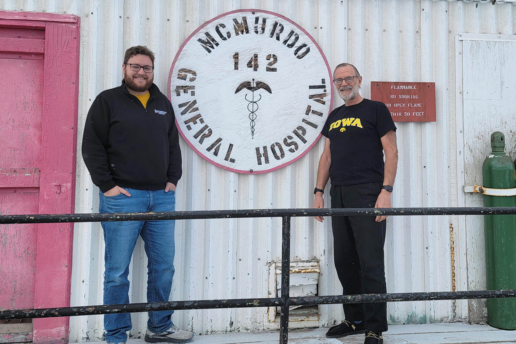 two university of Iowa medicine alums stand at a research station in antarctica