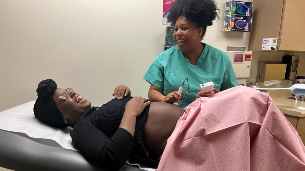 an obgyn shares a laugh with a patient during a medical visit