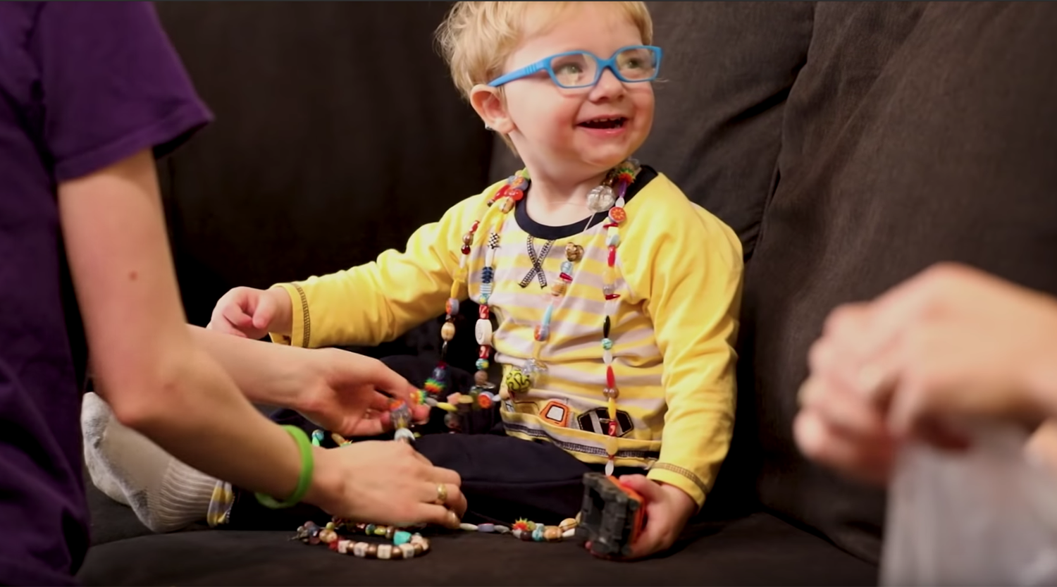 a young boy who received bone marrow transplant at the UI Stead Family Children's Hospital is shown wearing a necklace that symbolizes all the procedures he's had to endure