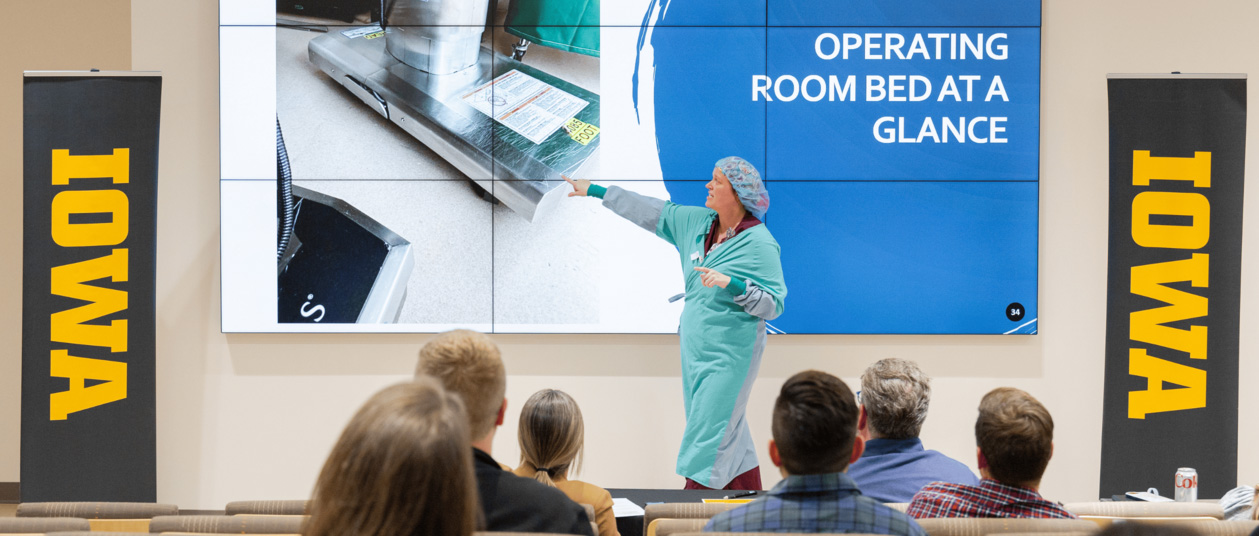 a nurse gives a presentation about a product that would better protect operating room beds