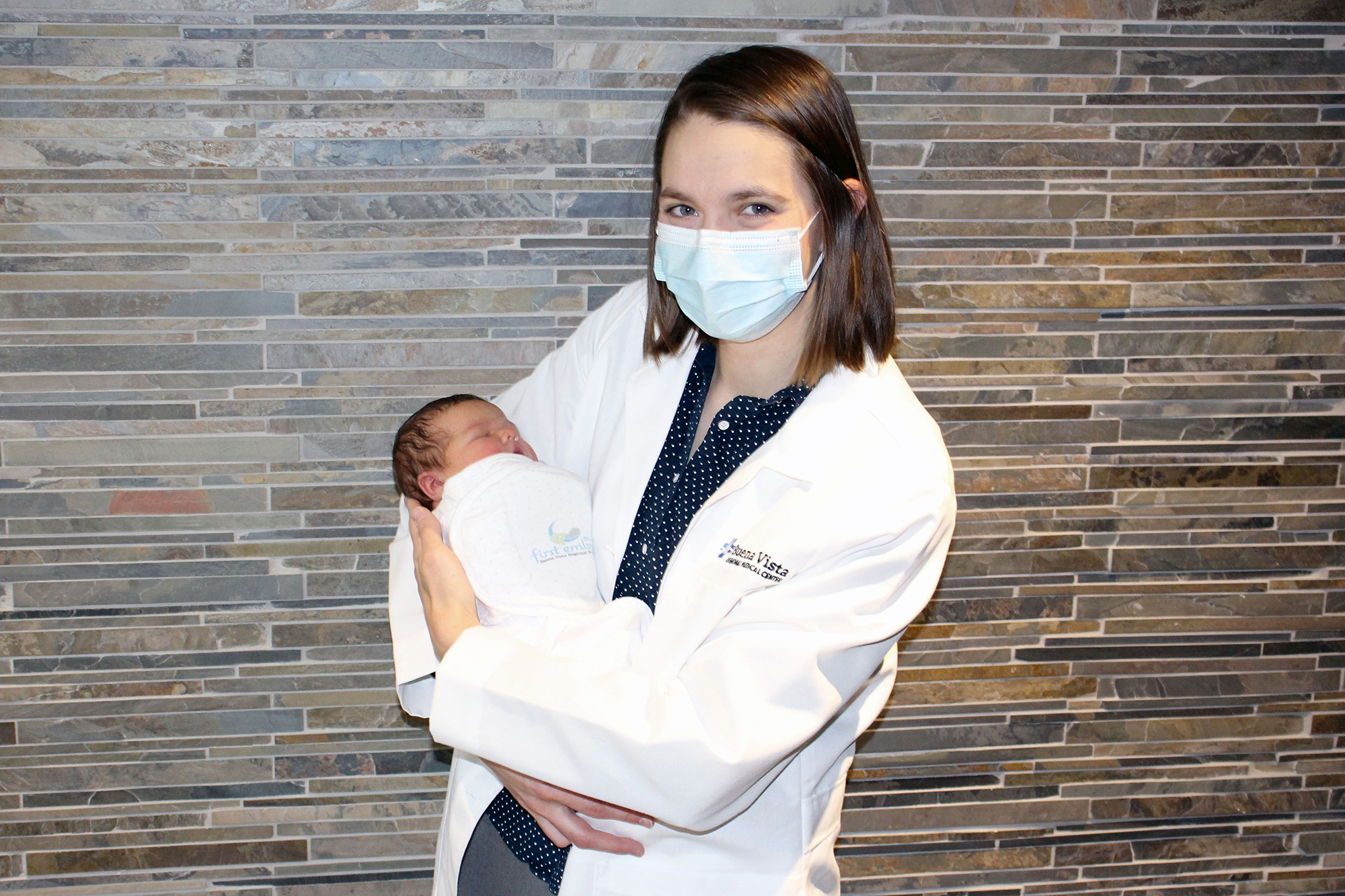 University of Iowa alum Liz Dupic holds a newborn baby