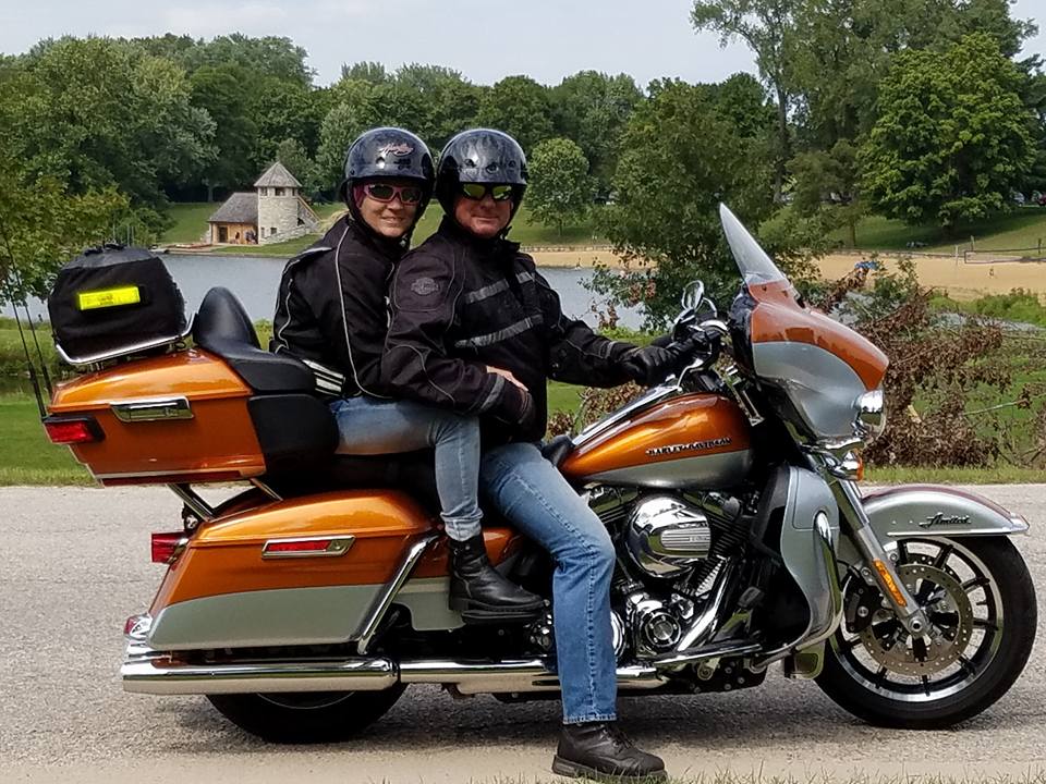 a man and a woman on a motorcycle