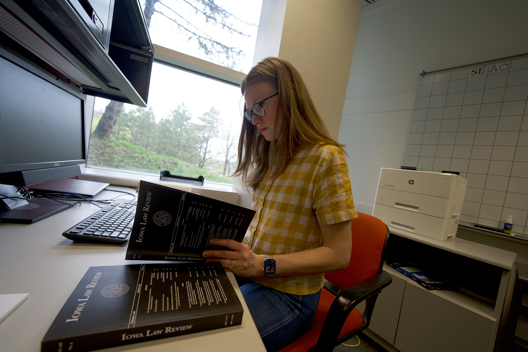 University of Iowa law grad Kate Conlow looking through an issue of Iowa Law Review, a journal on which she served as editor in chief