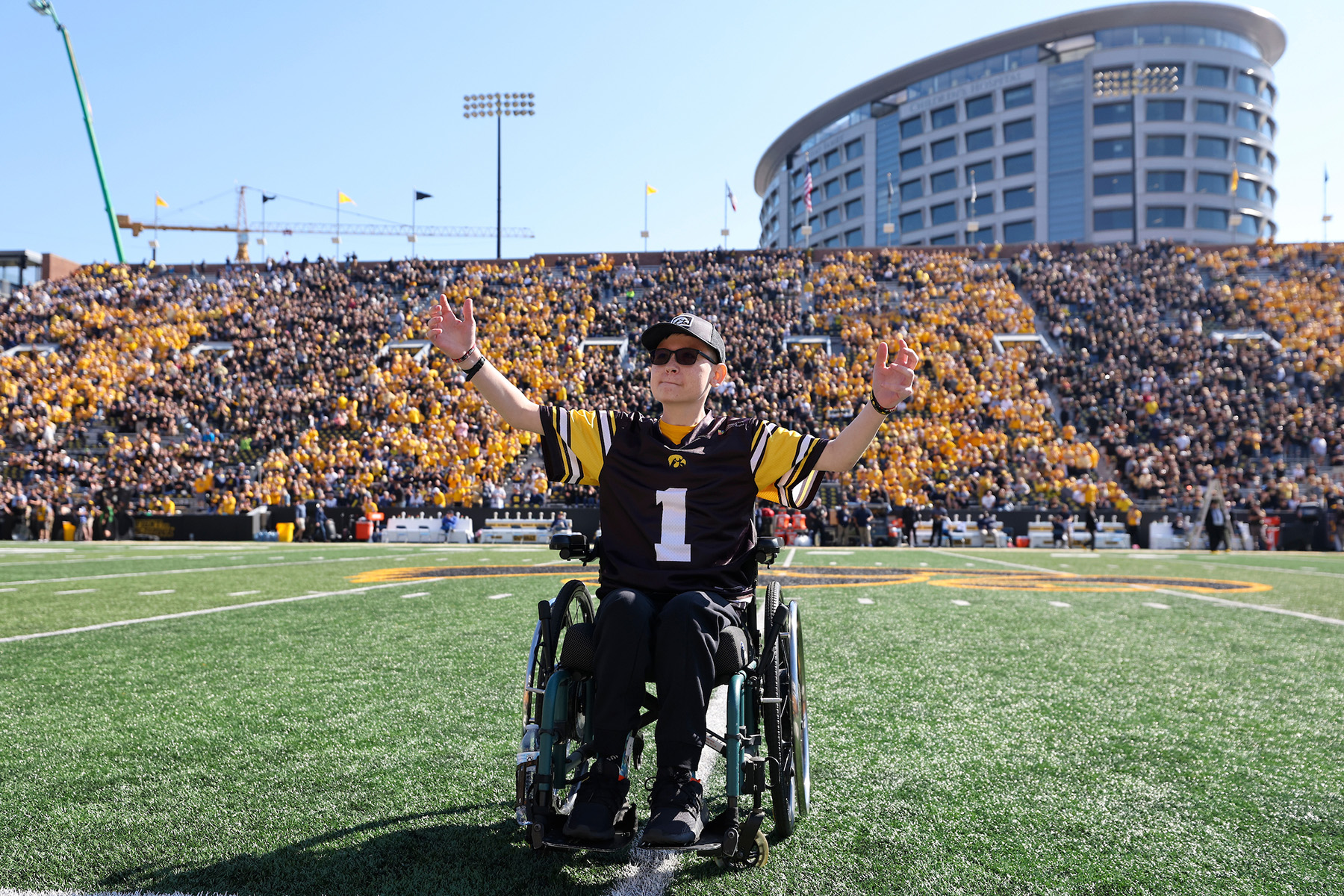 Kid Captain Adam Arp on the field at Kinnick Stadium