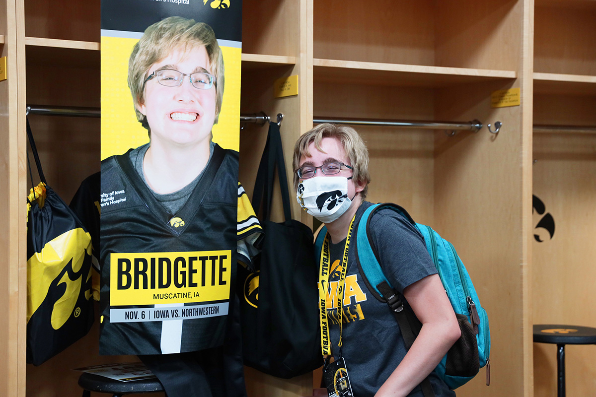 Kid Captain Bridgette Bissell in front of her locker on Kids Day at Kinnick
