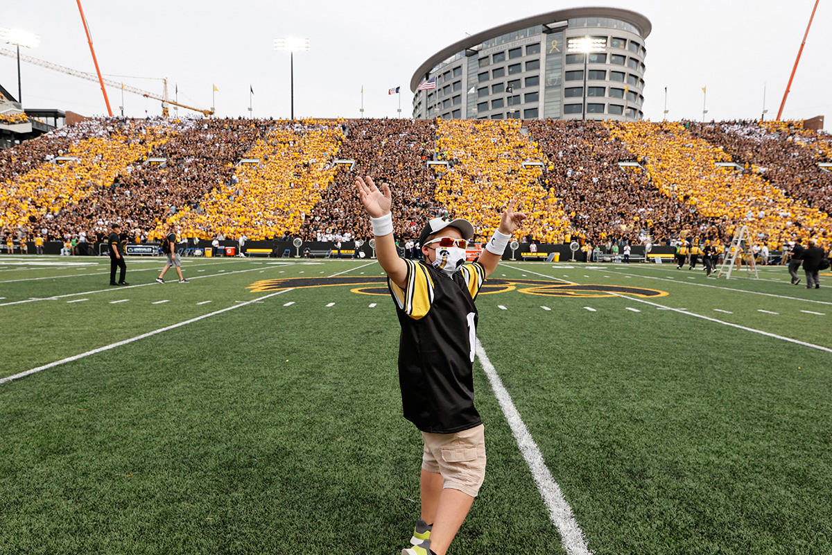 Kid Captain Kale Schmidt on the field at Kinnick Stadium