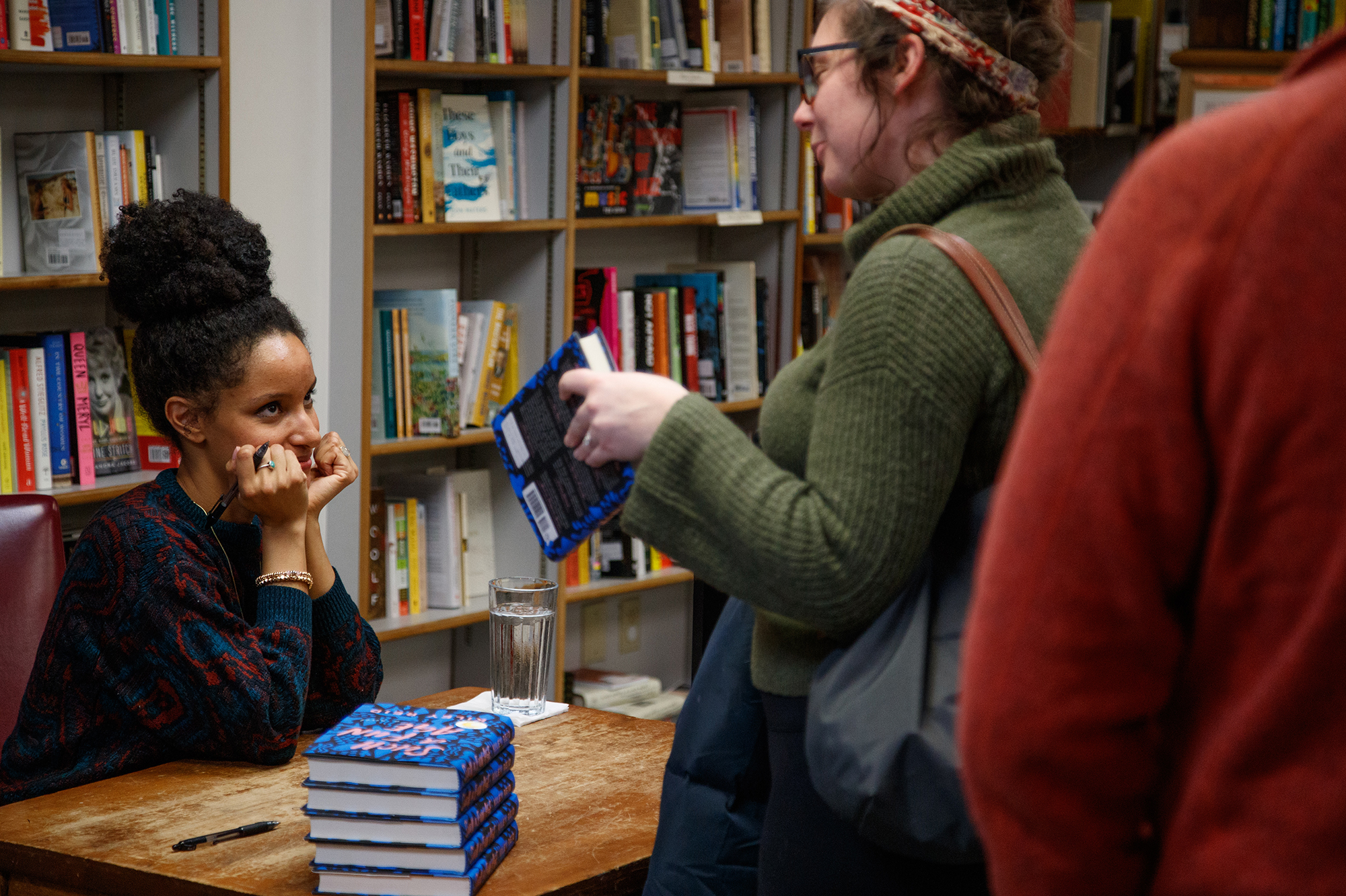 Iowa Writers' Workshop graduate Kiley Reid talks with an attendee at her Live from Prairie Lights reading Jan. 24 in Iowa City