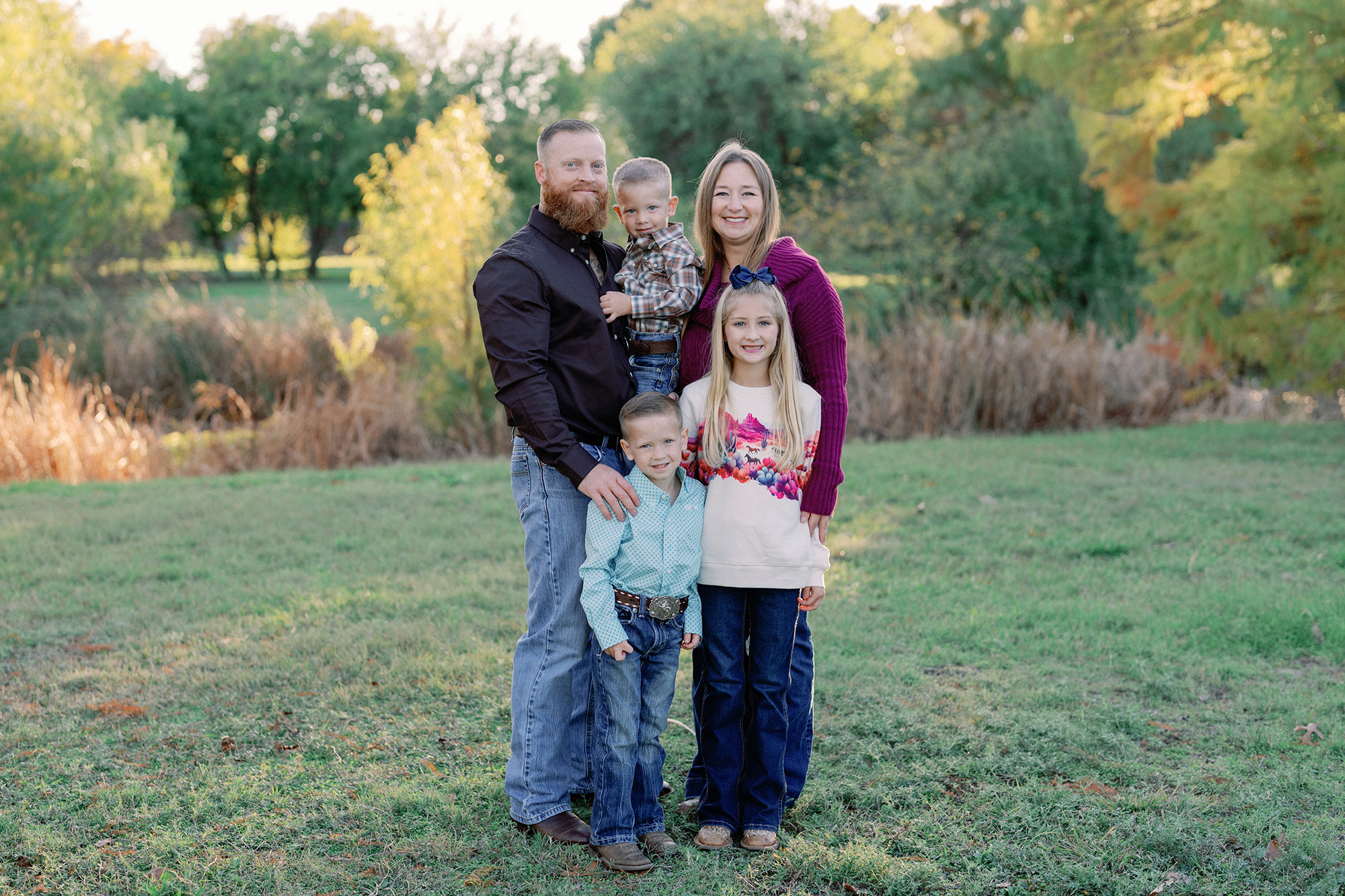 a family of five posing outdoors