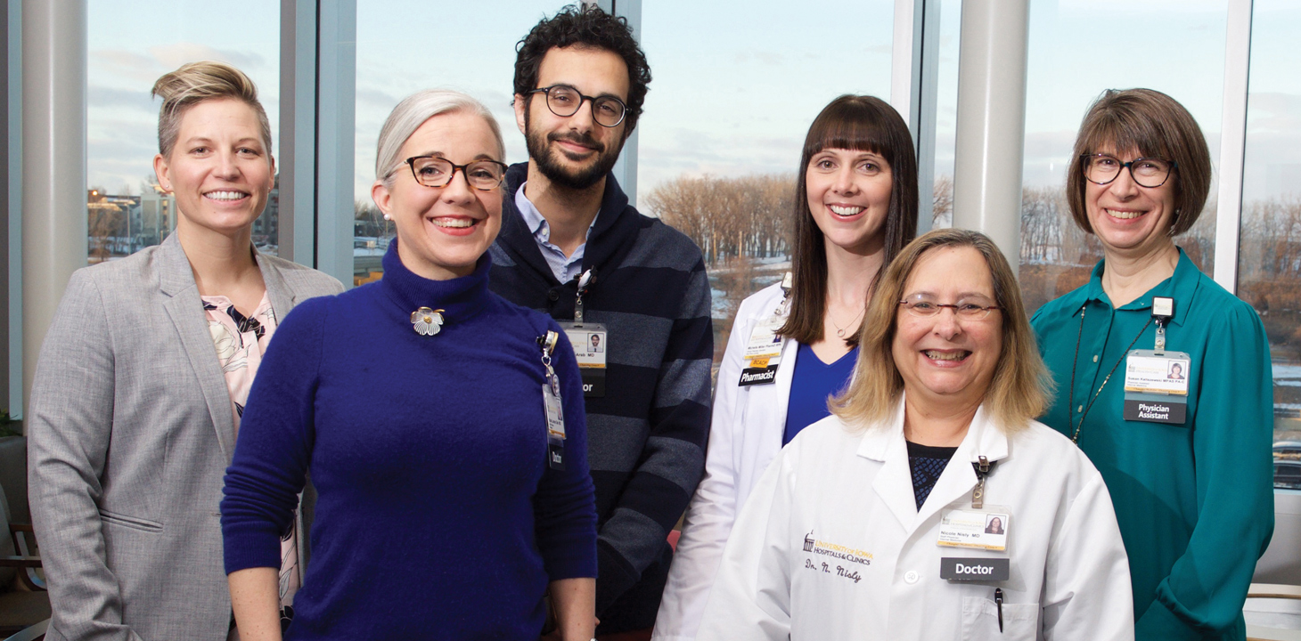 UI LGBTQ Clinic health care providers include, from left, Dr. Katherine Imborek (08MD, 11R), Dr. Katie Larson Ode, Dr. Emad Abou-Arab, pharmacist Michelle Miller, Dr. Nicole Nisly (93R), and physician assistant Susan Kaliszewski (91MS, 92MPA).