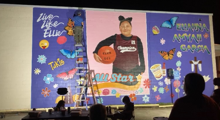 Abel Ortiz-Acosta paints a mural dedicated to Eliahna “Ellie” Garcia, who was killed in a shooting at at Robb Elementary School in Uvalde, Texas.