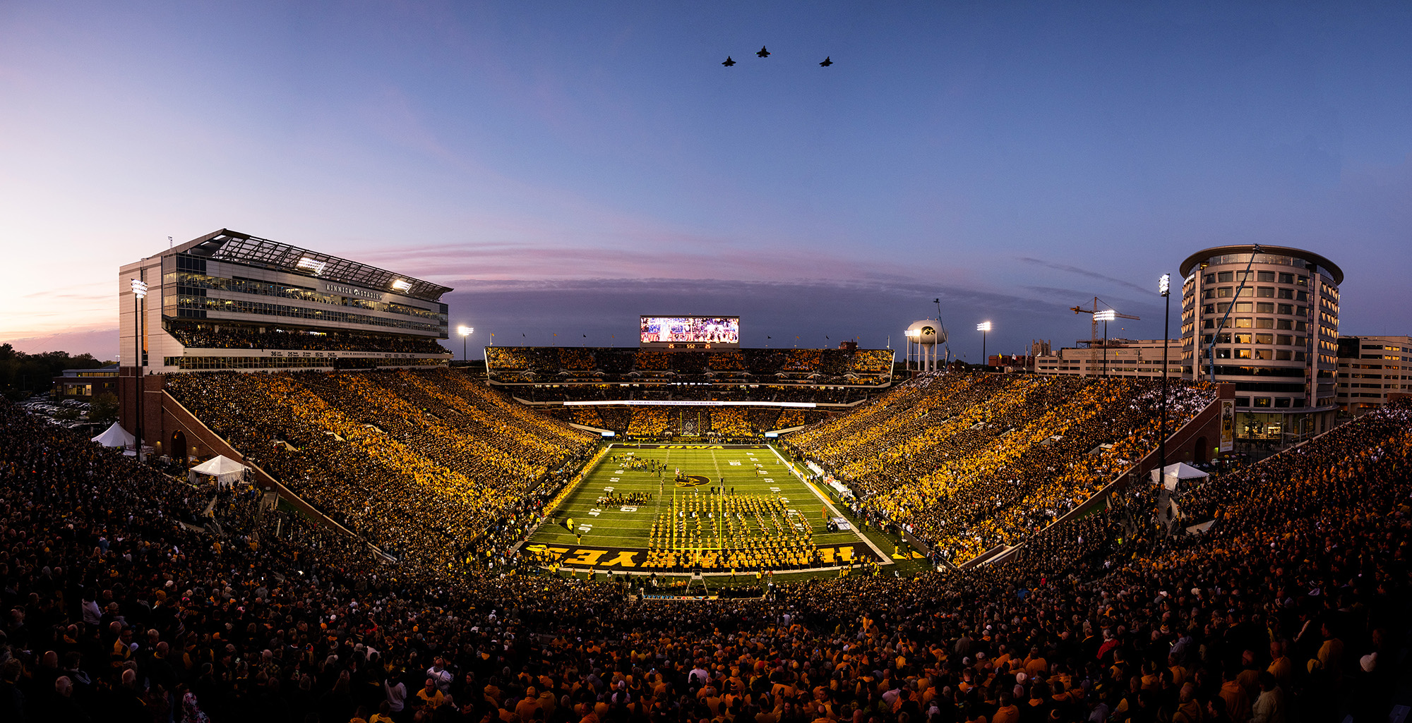 Air Force pilots, including University of Iowa alumni Michael Lynch and Nicholas Edwards, fly over Kinnick Stadium