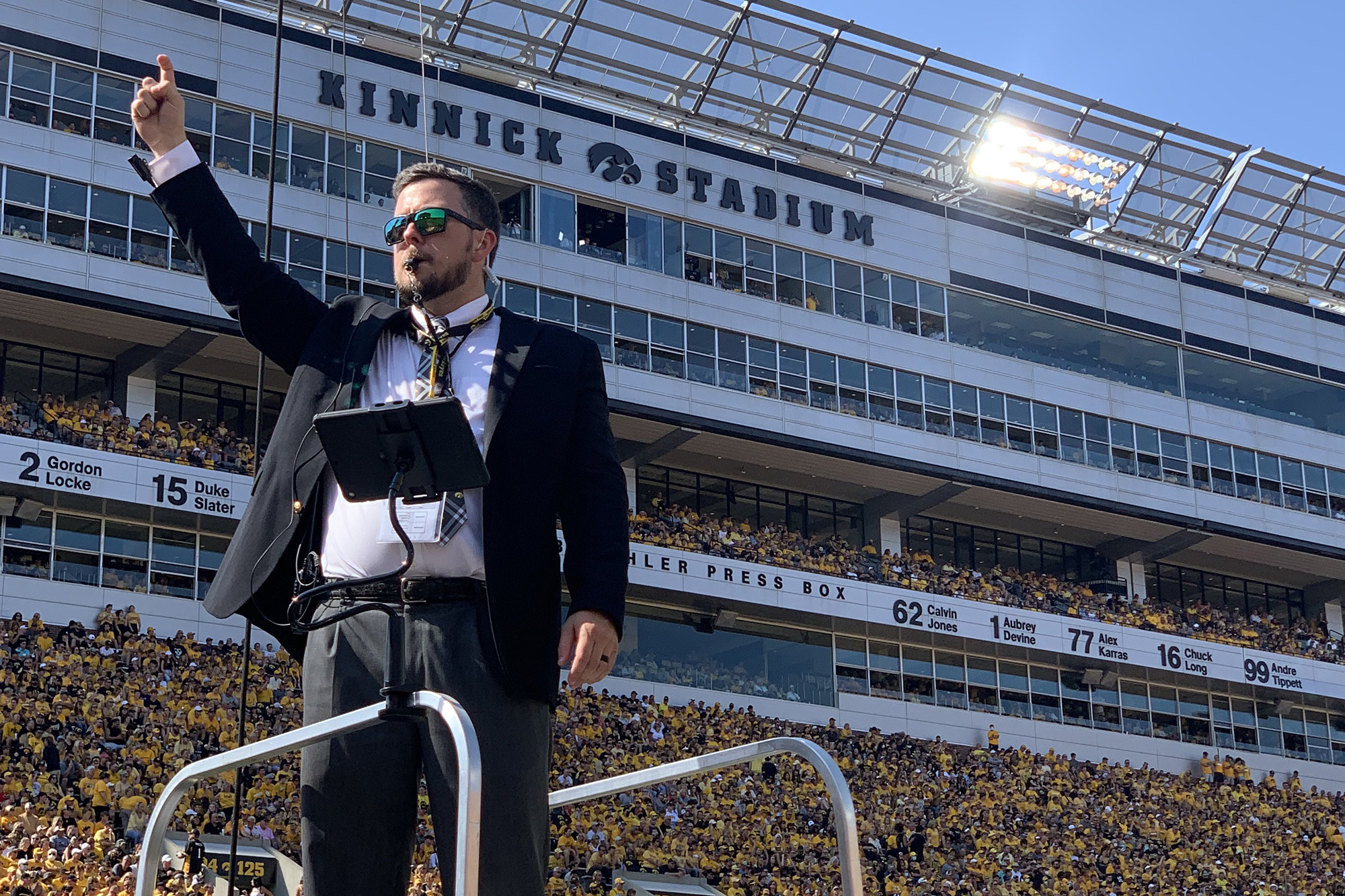 Tyler Strickland directing marching band at Kinnick