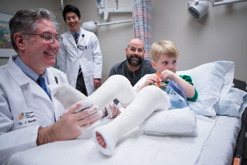 Dr. Morcuence working with a patient who is going through the casting process for clubfoot treatment