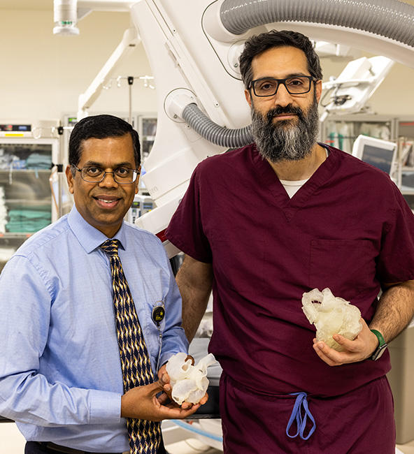 University of Iowa cardiologists Ravi Ashwath and Osamah Aldoss holding 3-D models