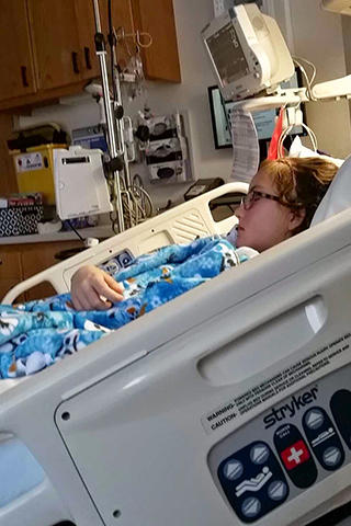 Hannah Bormann in a bed at University of Iowa Stead Family Children's Hospital