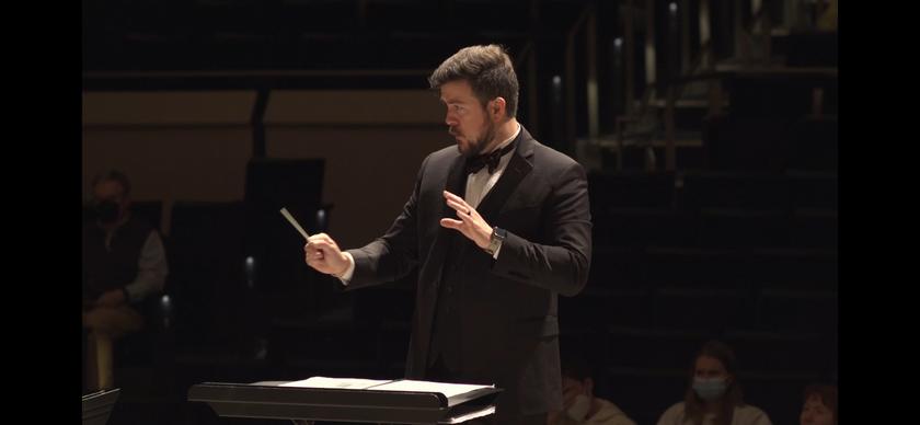 Tyler Strickland conducting in hall