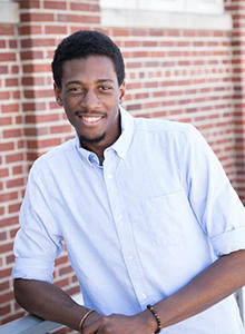 Jamal Nelson standing outside a building on the University of Iowa campus