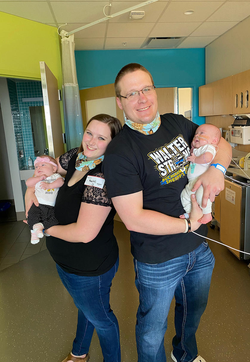 Naomi and Dylan Leech hold their children Emery and Warren