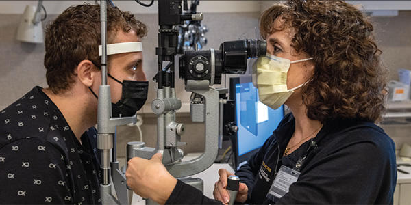 a health care professional conducts an eye examination